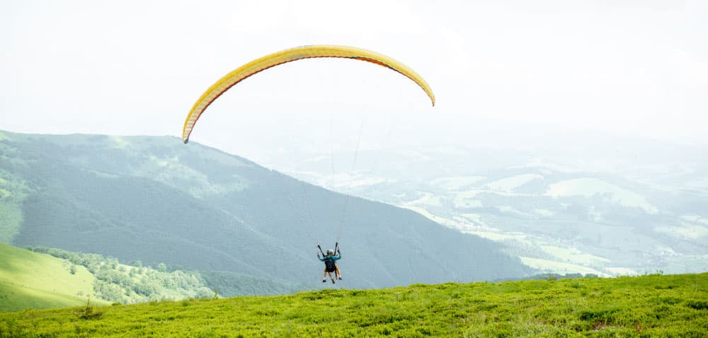 Paragliding over the Aburrá Valley university trek activity in Medellín